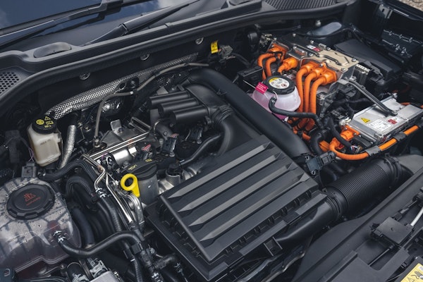 Motorraum eines CUPRA Formentor e-Hybrid – Kombination aus Verbrennungs- und Elektromotor mit markanten orangefarbenen Hochvoltkabeln und modernen Komponenten.